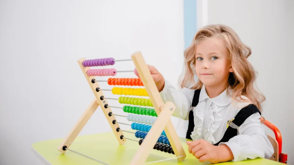 Child learning numbers using a colorful abacus