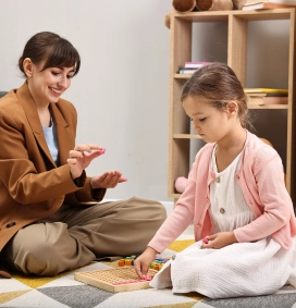 Child engaged in interactive online learning with therapist support