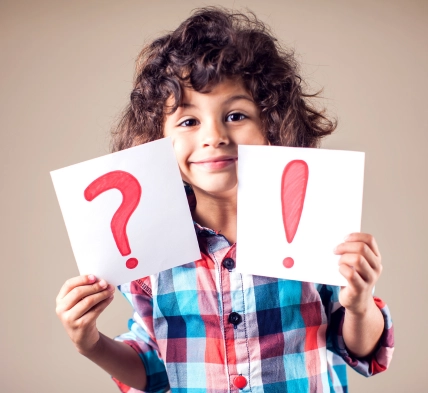 Child holding FAQ cards